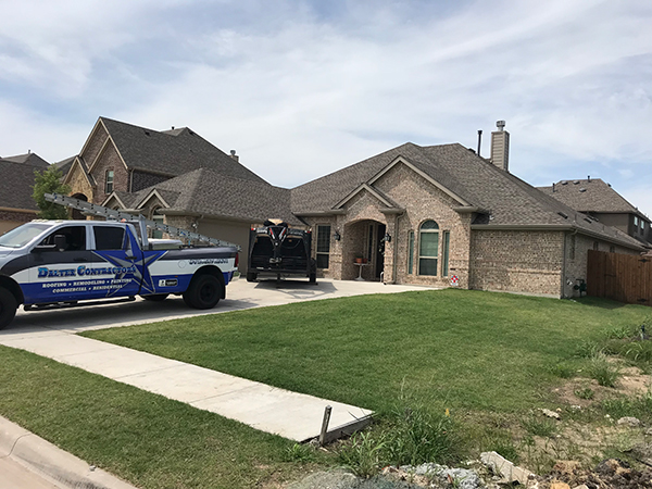 House with construction truck and green lawn.