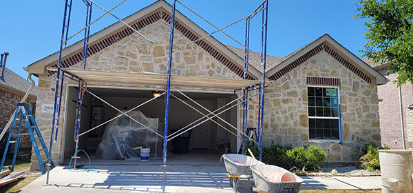 House under construction with scaffolding outside.